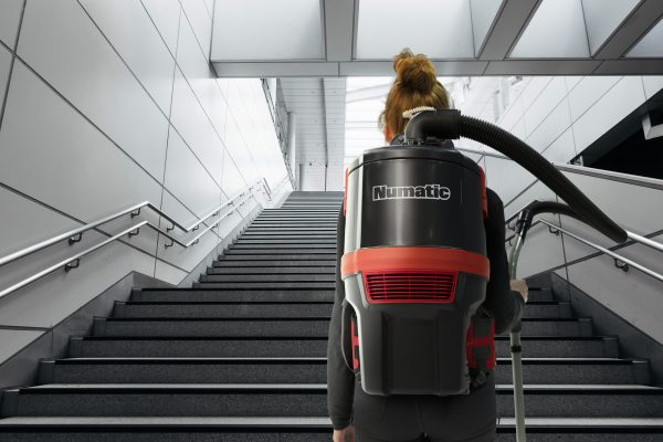 Woman walking up the stairs wearing a RSB150NX vacuum cleaner